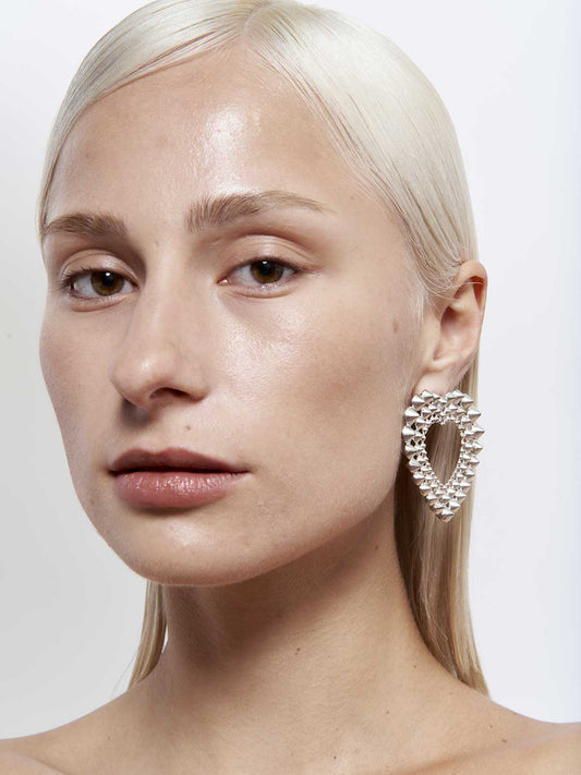 French designer punk rock couture fashion luxury silver trendy sustainable statement spike studded heart earrings