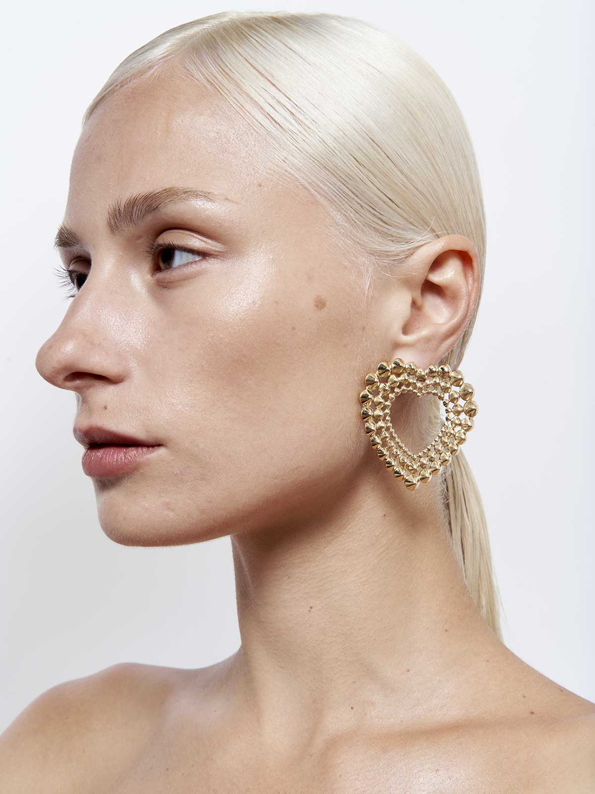 French designer punk rock couture fashion luxury gold trendy sustainable statement spike studded heart earrings 